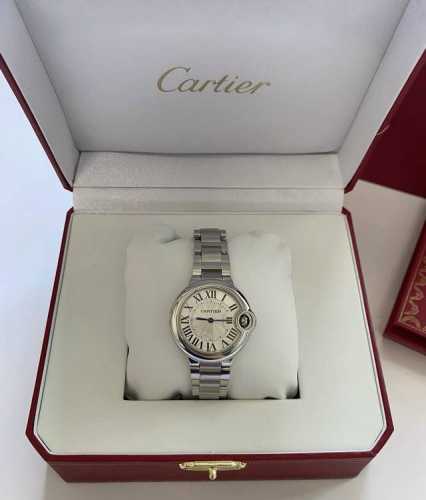 This Cartier watch features a bright silver case, a sleek round dial, a classic