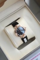 The black dial blends seamlessly with the classic and chic fan-shaped pattern,