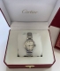 This Cartier watch features a bright silver case, a sleek round dial, a classic