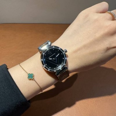 Lv Louis Vuitton watch features a sapphire crystal and imported Swiss movement.